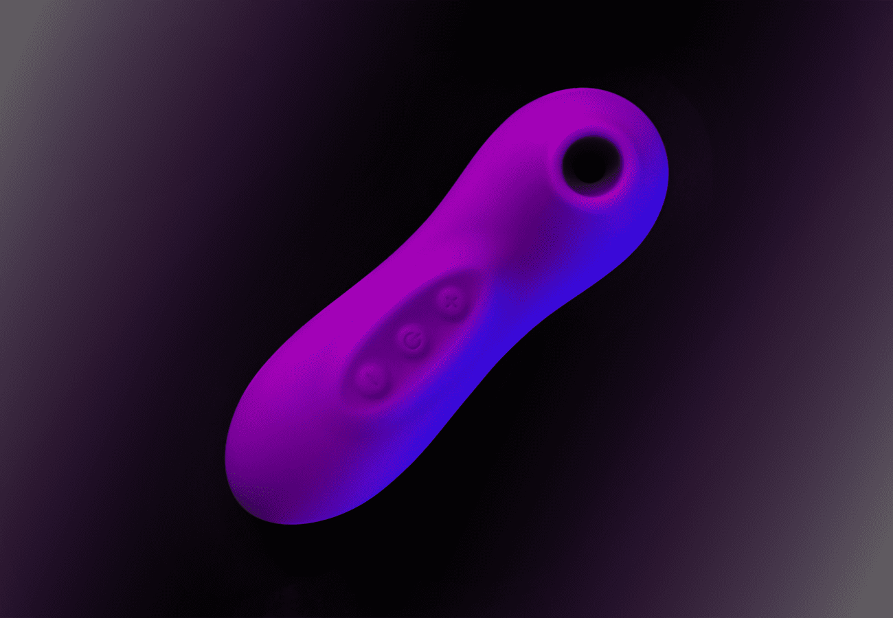 Vibrant purple stimulator sex toy against a black background